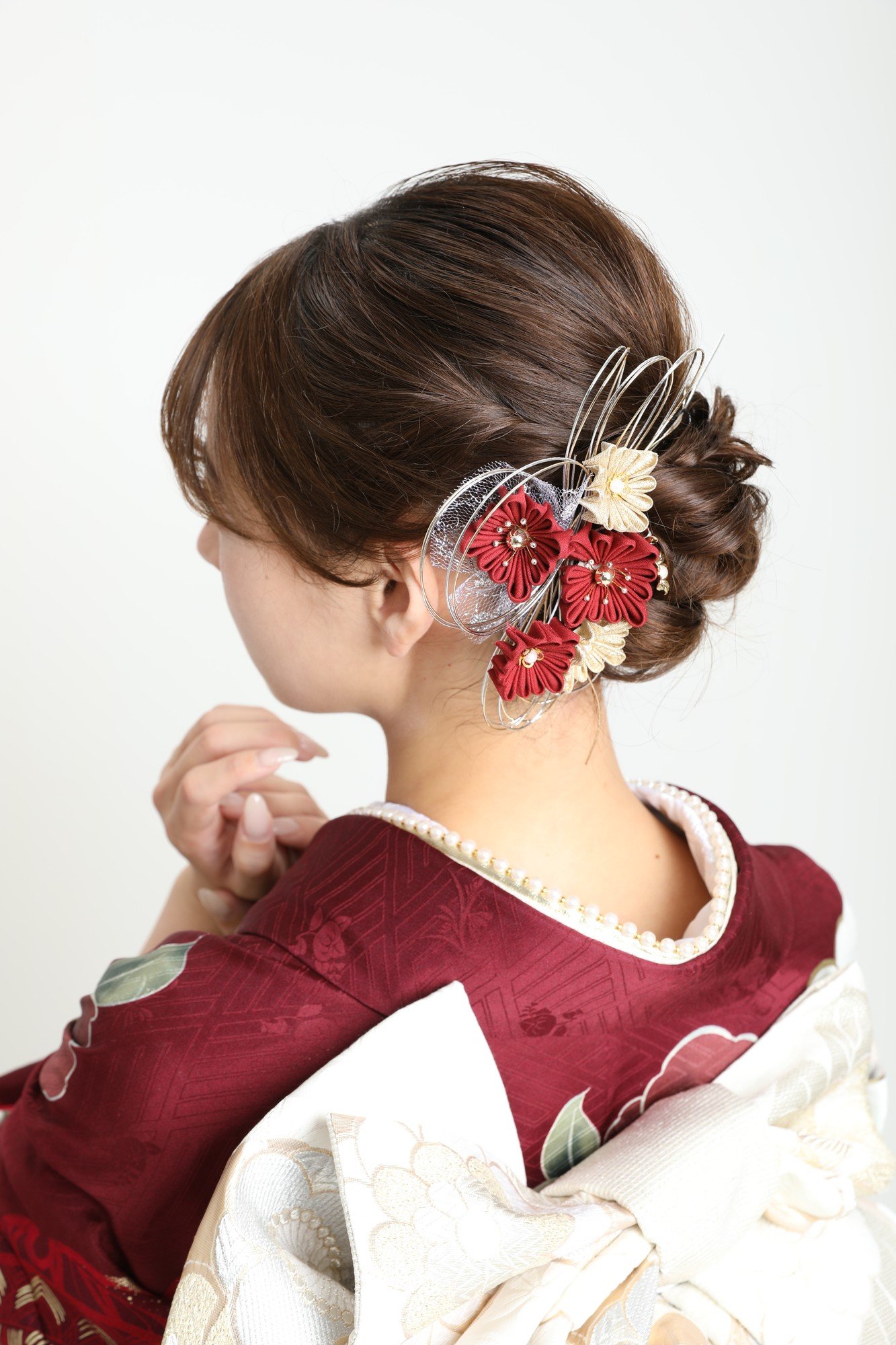 前撮りに向けて髪飾りを整えるヘアメイクスタッフ